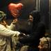 Alanna Gehringer holds a Valentine's Day balloon as her fiance Anthony ties it to her wrist at Camp Take Notice on Tuesday. Melanie Maxwell I AnnArbor.com